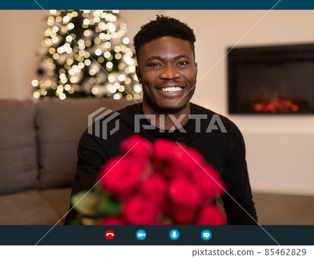 African Man Video Calling Holding Bouquet On Christmas Indoor African Man Video Calling Holding Bouquet On Christmas Indoor 85462829
