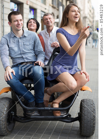 family of tourists enjoy a walk on the bike carriage family of tourists enjoy a walk on the bike carriage 85463219