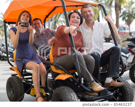 family of tourists enjoy a walk on the bike carriage family of tourists enjoy a walk on the bike carriage 85463237