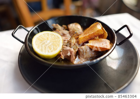 Kleftiko from mutton by Cyprus. Kleftiko is a dish national cuisine of Cyprus. Stewed lamb meat served with potatoes and lemon. Kleftiko from mutton by Cyprus. Kleftiko is a dish national cuisine of Cyprus. Stewed lamb meat served with potatoes and lemon. 85463304