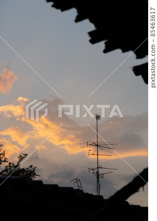 Sunset twilight of timelapse with nice orange sky and peaceful calm evening. Urban city with beauty landscape. Satellite above the roof. Silhouette. Sunset twilight of timelapse with nice orange sky and peaceful calm evening. Urban city with beauty landscape. Satellite above the roof. Silhouette. 85463617