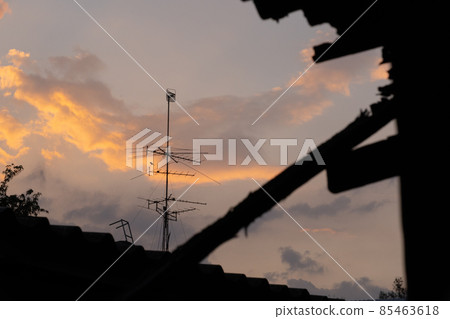 Sunset twilight of timelapse with nice orange sky and peaceful calm evening. Urban city with beauty landscape. Satellite above the roof. Silhouette. Sunset twilight of timelapse with nice orange sky and peaceful calm evening. Urban city with beauty landscape. Satellite above the roof. Silhouette. 85463618