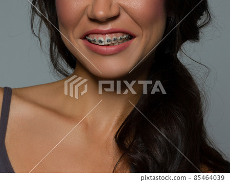 Close-up of sexy female lips with tongue. Clean skin and a clear lip contour are outlined with a fashionable pink lipstick. White teeth and the beauty of smile for stamotologii, spa or cosmetology Close-up of sexy female lips with tongue. Clean skin and a clear lip contour are outlined with a fashionable pink lipstick. White teeth and the beauty of smile for stamotologii, spa or cosmetology 85464039