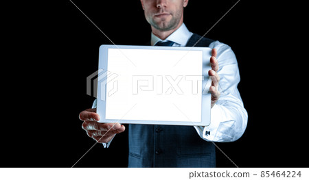 Tablet mockup. Businessman holding mobile tablet blank screen. Smart technology device mock up isolated on black background. Information message content with clipping path. Tablet mockup. Businessman holding mobile tablet blank screen. Smart technology device mock up isolated on black background. Information message content with clipping path. 85464224