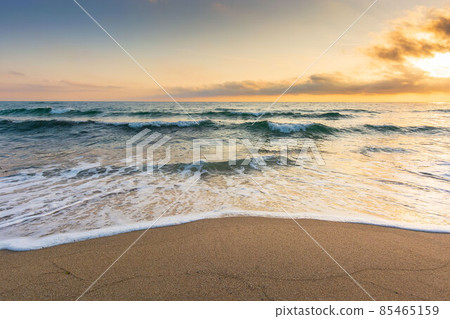 golden sand on the beach in summer. beautiful glowing clouds above the horizon. panoramic seascape at sunrise. relaxing summer mood in morning light. vacation concept background 85465159