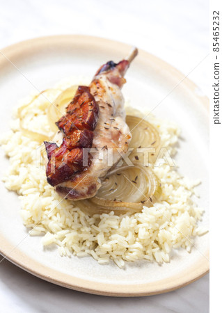 rabbit leg baked with bacon and onion served with rice rabbit leg baked with bacon and onion served with rice 85465232