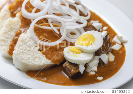 beef goulash with onion rings, boiled egg and dumplings 85465233