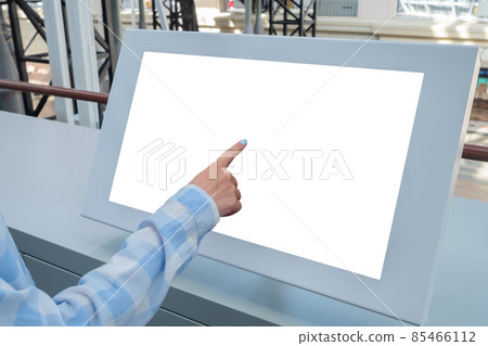 Woman hand touching interactive white touchscreen display kiosk: close up Woman hand touching interactive white touchscreen display kiosk: close up 85466112
