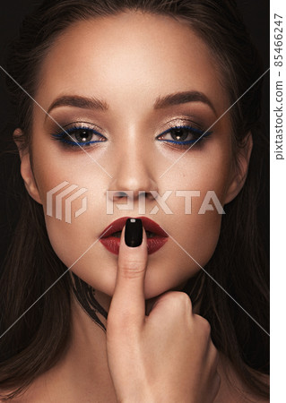 Beautiful girl with bright fashionable make-up and long thick hair. Beauty face. 85466247