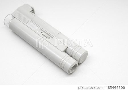 Compact mini microscope for printing and design. Magnifying device. Selective focus, copy space, white background Compact mini microscope for printing and design. Magnifying device. Selective focus, copy space, white background 85466300