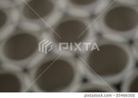 Abstract background. Cluster holes. Blurred cardboard sleeves. Defocused spools and bobbins for winding paper. Abstract background. Cluster holes. Blurred cardboard sleeves. Defocused spools and bobbins for winding paper. 85466308