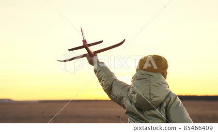 little child runs at sunset with toy plane in his hands, happy family life, childhood dream of flying, running kid fantasizes about pilot's flight, cheerful baby runner in nature travels on weekends little child runs at sunset with toy plane in his hands, happy family life, childhood dream of flying, running kid fantasizes about pilot's flight, cheerful baby runner in nature travels on weekends 85466409