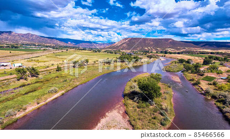 Split river through lush forest by desert mountains Split river through lush forest by desert mountains 85466566