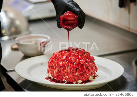 Chocolate pumpkin cupcake, decorated with icing in shape of brain. Selective focus. From series Funny halloween. Chocolate pumpkin cupcake, decorated with icing in shape of brain. Selective focus. From series Funny halloween. 85466803