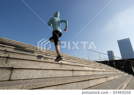 Fitness sports woman running up stairs in city Fitness sports woman running up stairs in city 85469208