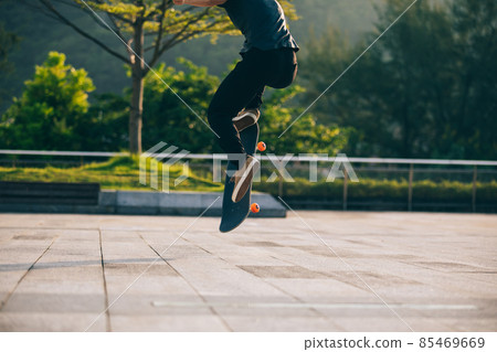 Skateboarder skateboarding outdoors in city 85469669