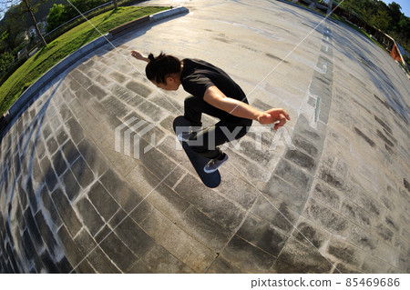 Skateboarder skateboarding outdoors in city 85469686
