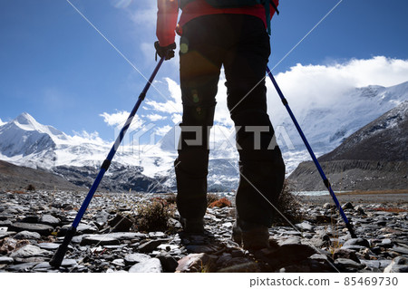 Woman hiker hiking in high altitude winter mountains 85469730