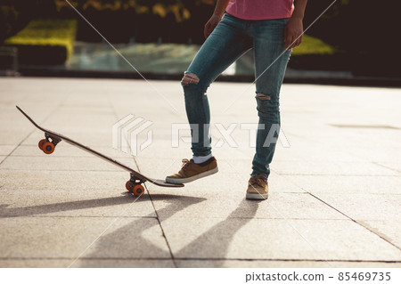 Skateboarder skateboarding outdoors in city 85469735