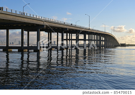 Rickenbacker Causeway bridge in Miami, Florida reflected in Biscayne Bay. Rickenbacker Causeway bridge in Miami, Florida reflected in Biscayne Bay. 85470015