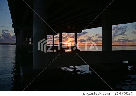 Rickenbacker Causeway bridge silhouetted against sunrise in Miami, Florida. Rickenbacker Causeway bridge silhouetted against sunrise in Miami, Florida. 85470034
