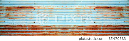 The texture of the corrugated iron plate fence with old rust. Horizontally long panoramic background material. The texture of the corrugated iron plate fence with old rust. Horizontally long panoramic background material. 85470383