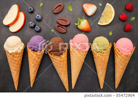 Flat lay ice cream cones collection on dark stone background . Blank crispy ice cream cone with copy space for sweets menu design. 85472904