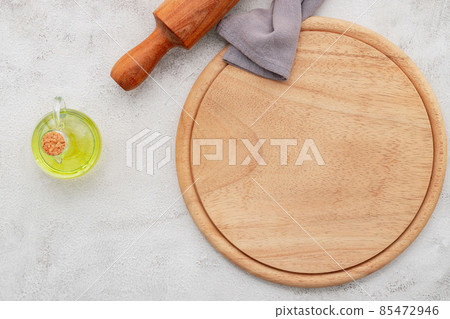 Empty wooden pizza platter set up on white concrete. Pizza board on white concrete background flat lay and copy space. 85472946