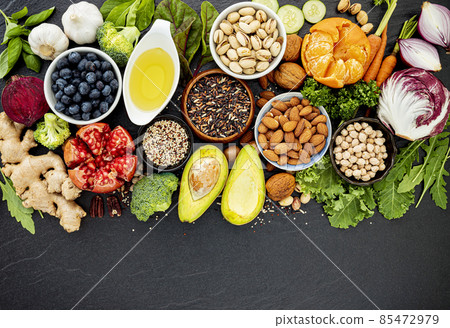 Ingredients for the healthy foods selection. The concept of healthy food set up on dark stone background. 85472979