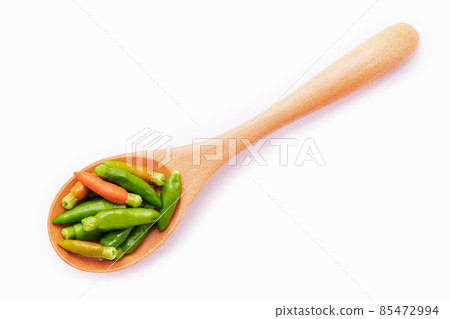 Fresh Thai bird's eye chillies in wooden spoon isolated on white background. 85472994