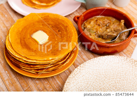 Machanka and pancakes - Belarusian cuisine, traditional assorted dishes closeup Machanka and pancakes - Belarusian cuisine, traditional assorted dishes closeup 85473644
