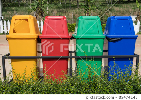 Multicolours recycle bin setting at the public park. A container used to hold recyclables before they are taken to recycling centre. Multicolours recycle bin setting at the public park. A container used to hold recyclables before they are taken to recycling centre. 85474143