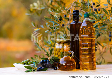 Olive tree and oil products on table outdoors Olive tree and oil products on table outdoors 85474274