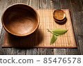 Empty wooden bowl on natural background. 85476578
