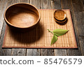 Empty wooden bowl on natural background. 85476579