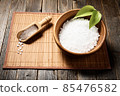 Wooden bowl with salt on natural background. 85476582