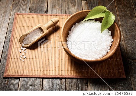 Wooden bowl with salt on natural background. 85476582