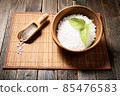 Wooden bowl with salt on natural background. 85476583
