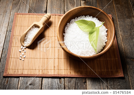 Wooden bowl with salt on natural background. 85476584