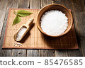 Wooden bowl with salt on natural background. 85476585