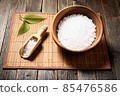 Wooden bowl with salt on natural background. 85476586