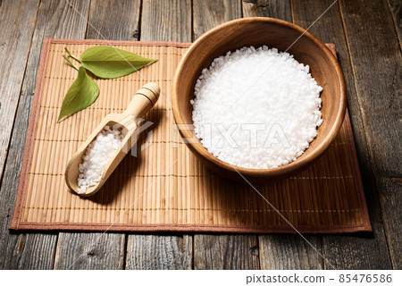 Wooden bowl with salt on natural background. 85476586