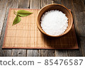 Wooden bowl with salt on natural background. 85476587