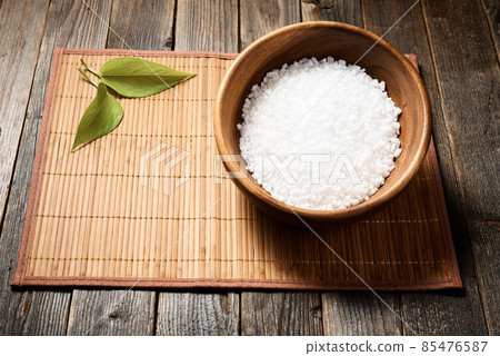 Wooden bowl with salt on natural background. 85476587