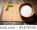 Wooden bowl with salt on natural background. 85476588