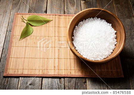 Wooden bowl with salt on natural background. 85476588