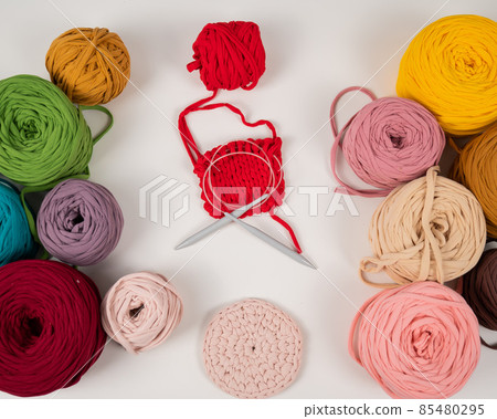 cotton yarn knitting pattern on white table. cotton yarn knitting pattern on white table. 85480295