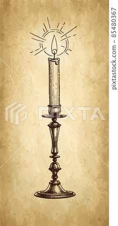 Burning candle in a candlestick 85480367