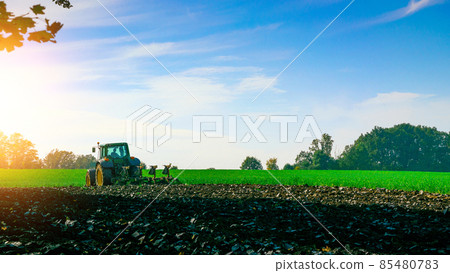 Tractor farm. Agriculture farm machinery on landscape land field. Farmer machine equipment for crop. Tractor farm fields concept. Tractor farm. Agriculture farm machinery on landscape land field. Farmer machine equipment for crop. Tractor farm fields concept. 85480783