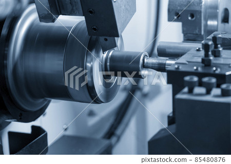 The  CNC lathe machine boring cutting the metal pipe  parts. 85480876